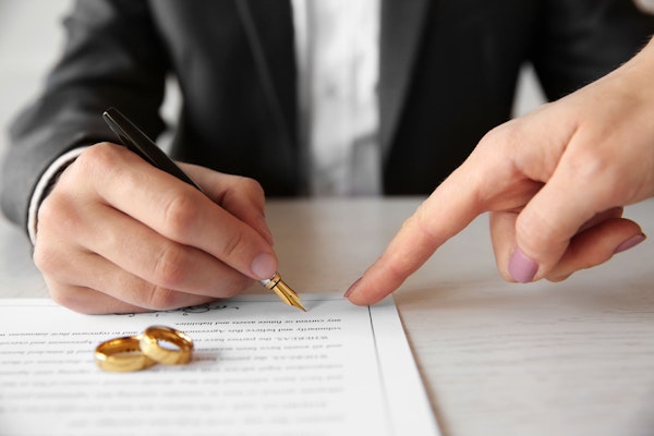 Man signing prenuptial agreement