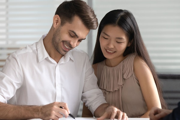 Couple signing postnuptial agreement