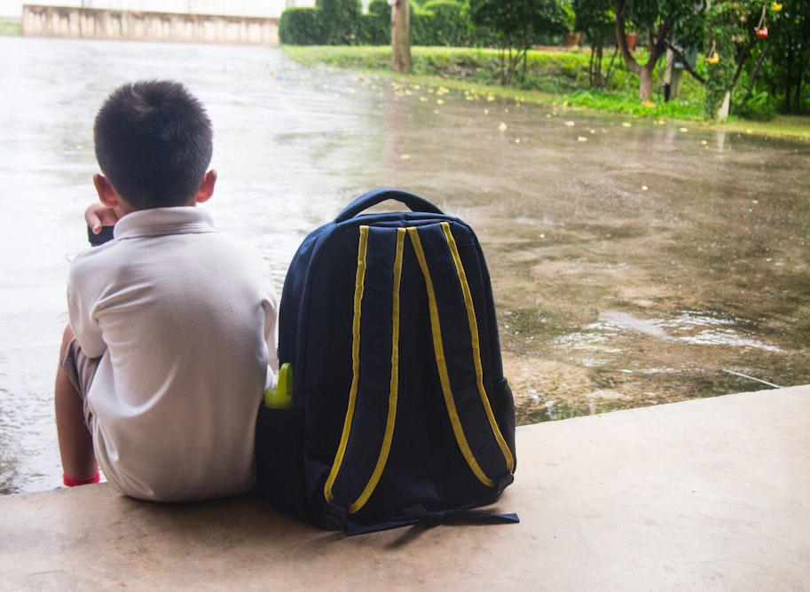 Young boy waiting at school for a parent