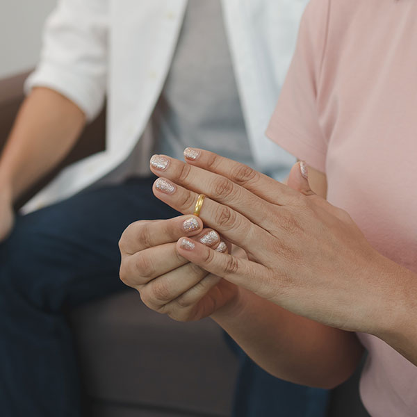 Woman taking off her wedding ring