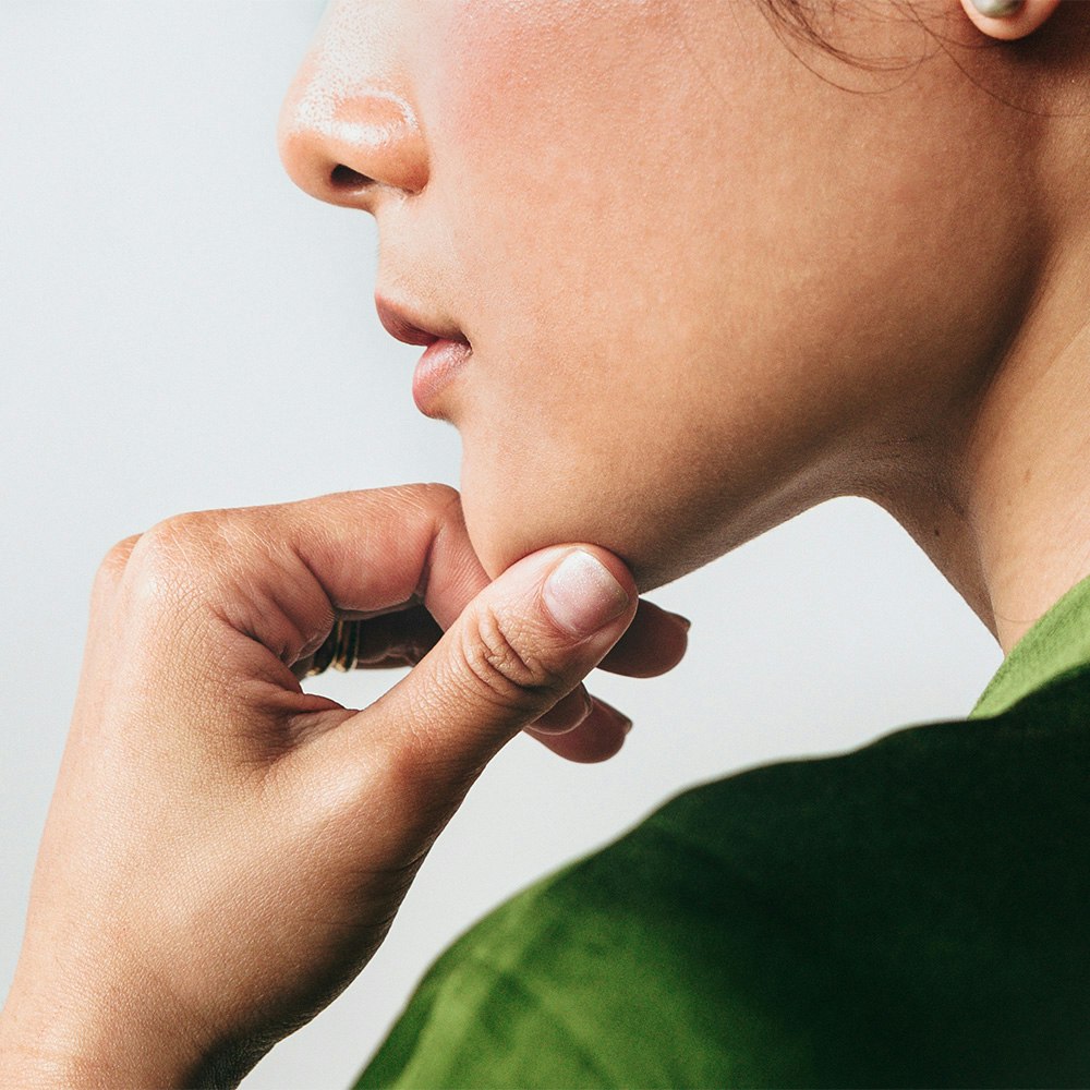 Person resting their chin on their hand