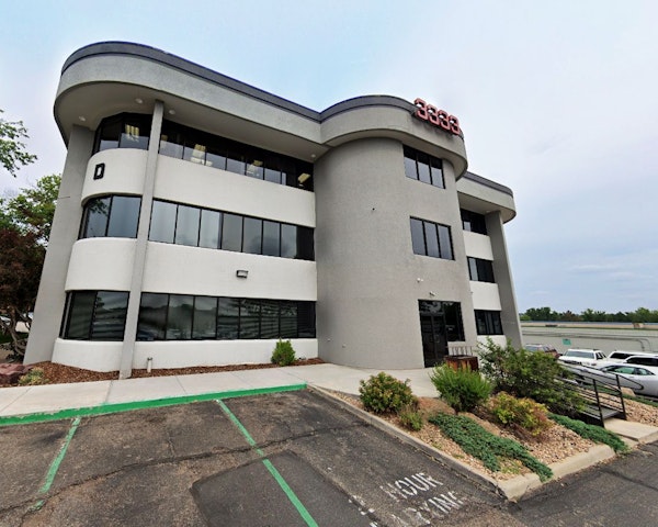 Dr. Bauer sitting with his wife and children in front of a mountain view