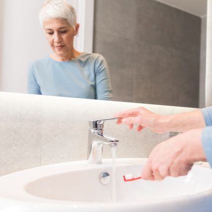 A woman about to brush her teeth