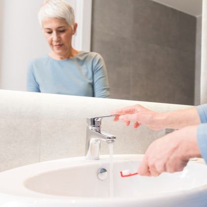 A woman about to brush her teeth