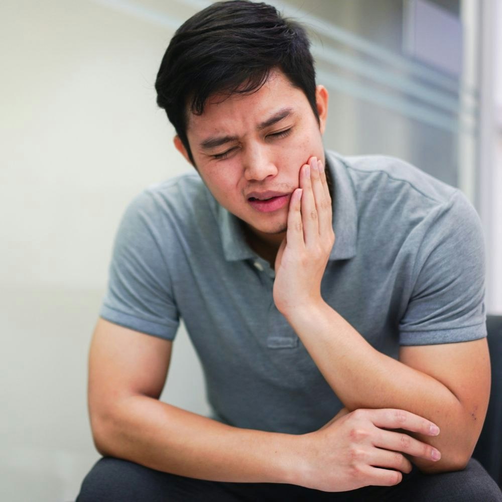 A man experiencing tooth pain