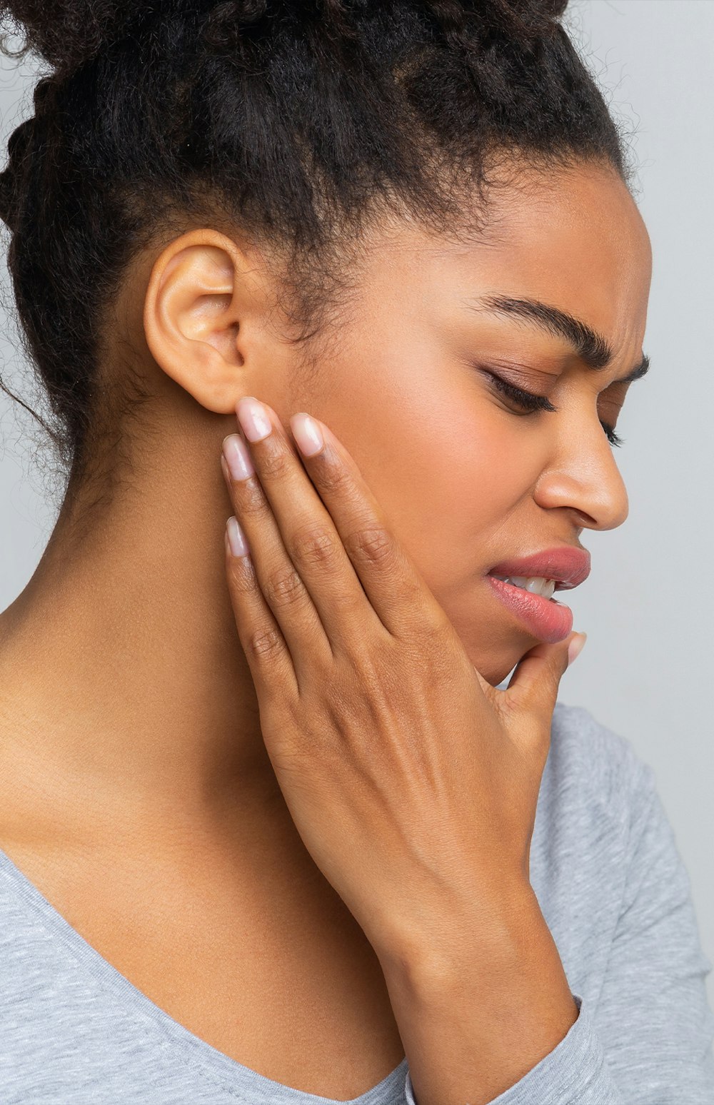Woman holding jaw in pain