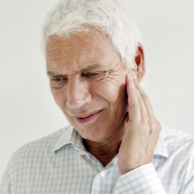 Older man clutching jaw