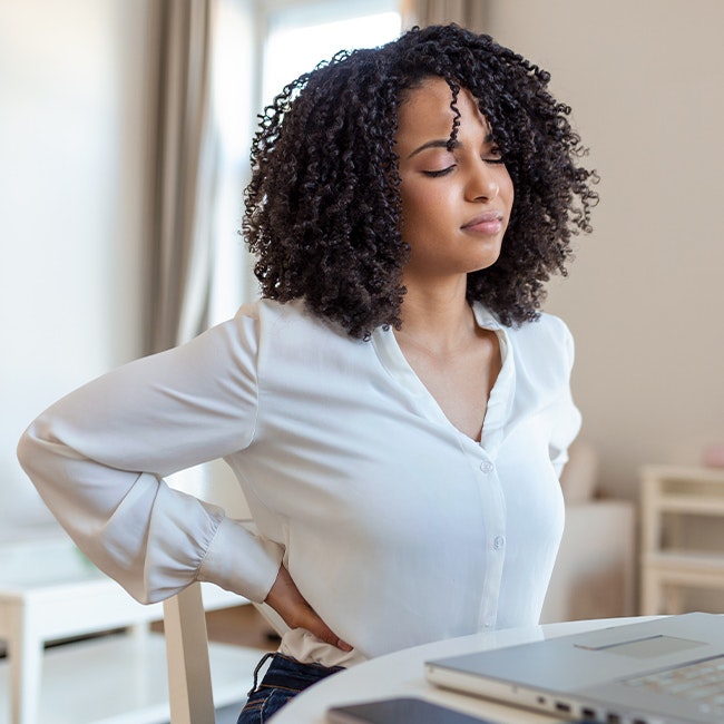 Woman with hands on lower back