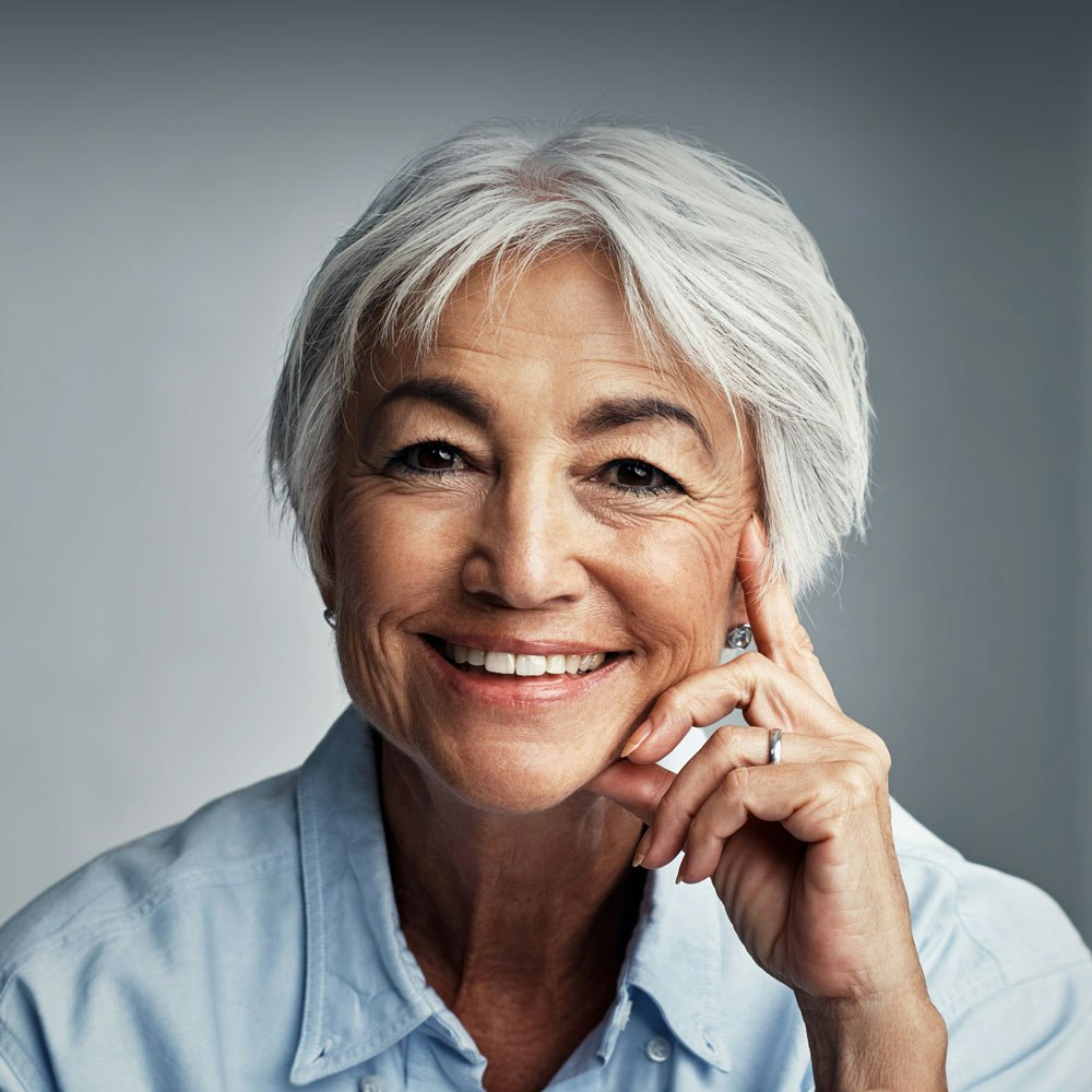 Smiling woman after full mouth reconstruction