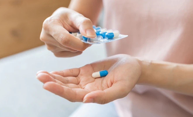Woman taking antibiotics