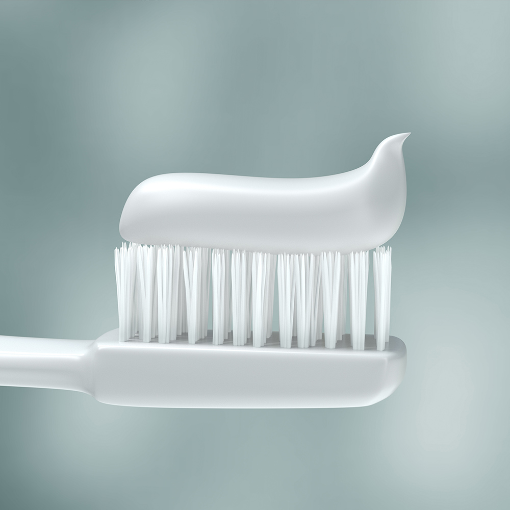 A white toothbrush with toothpaste