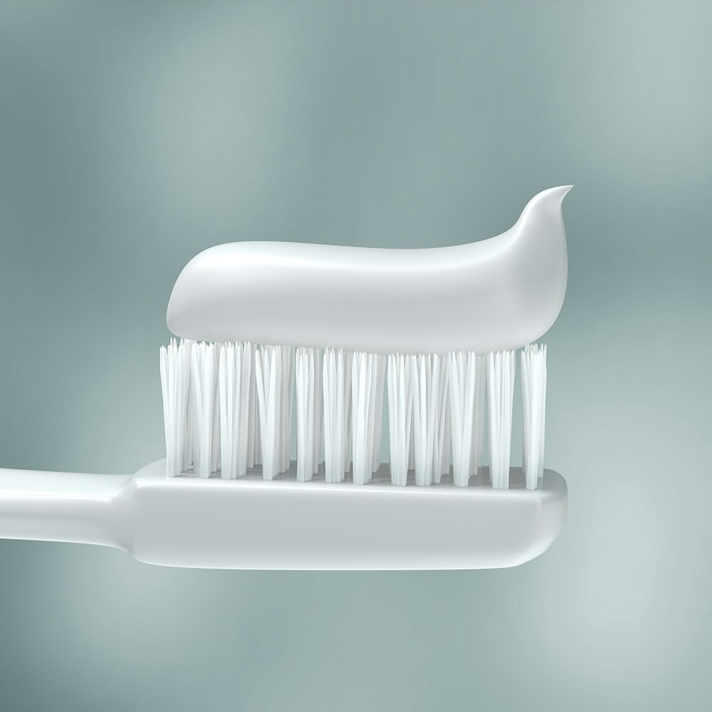 A white toothbrush with toothpaste