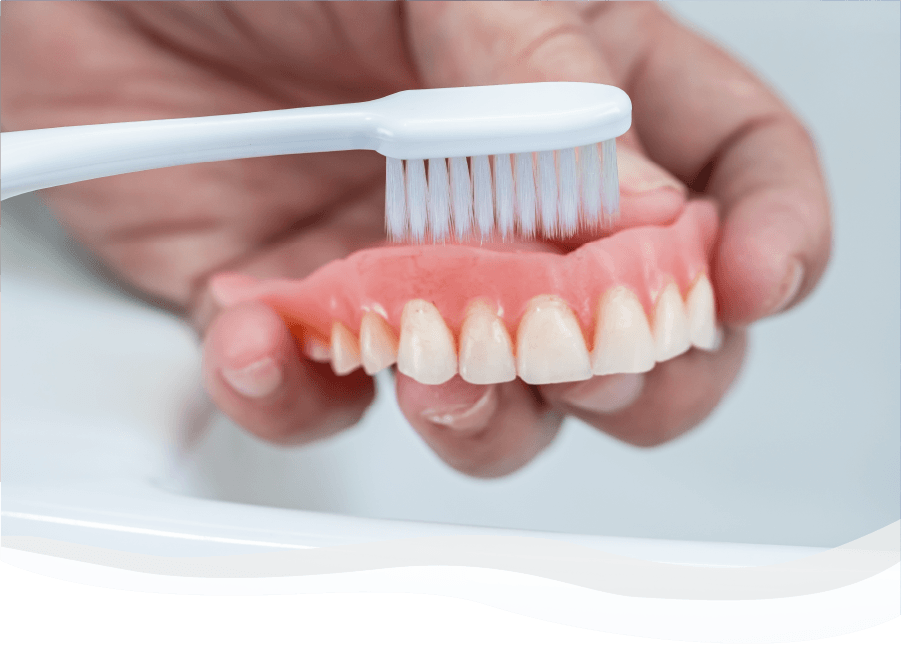 Toothbrush cleaning denture