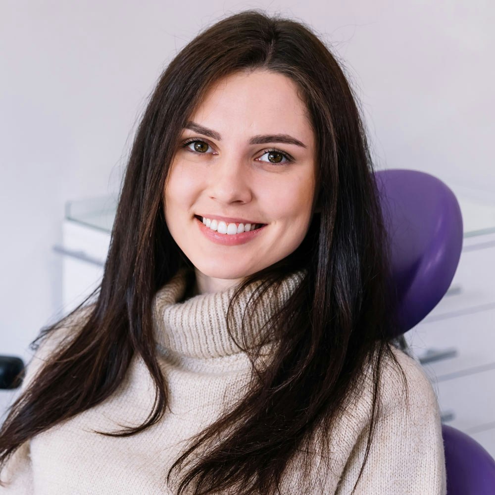 Female patient smiling brightly in dentist office