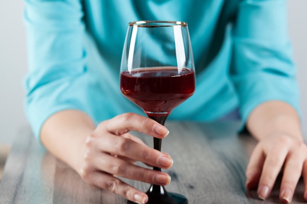 person holding a glass of wine