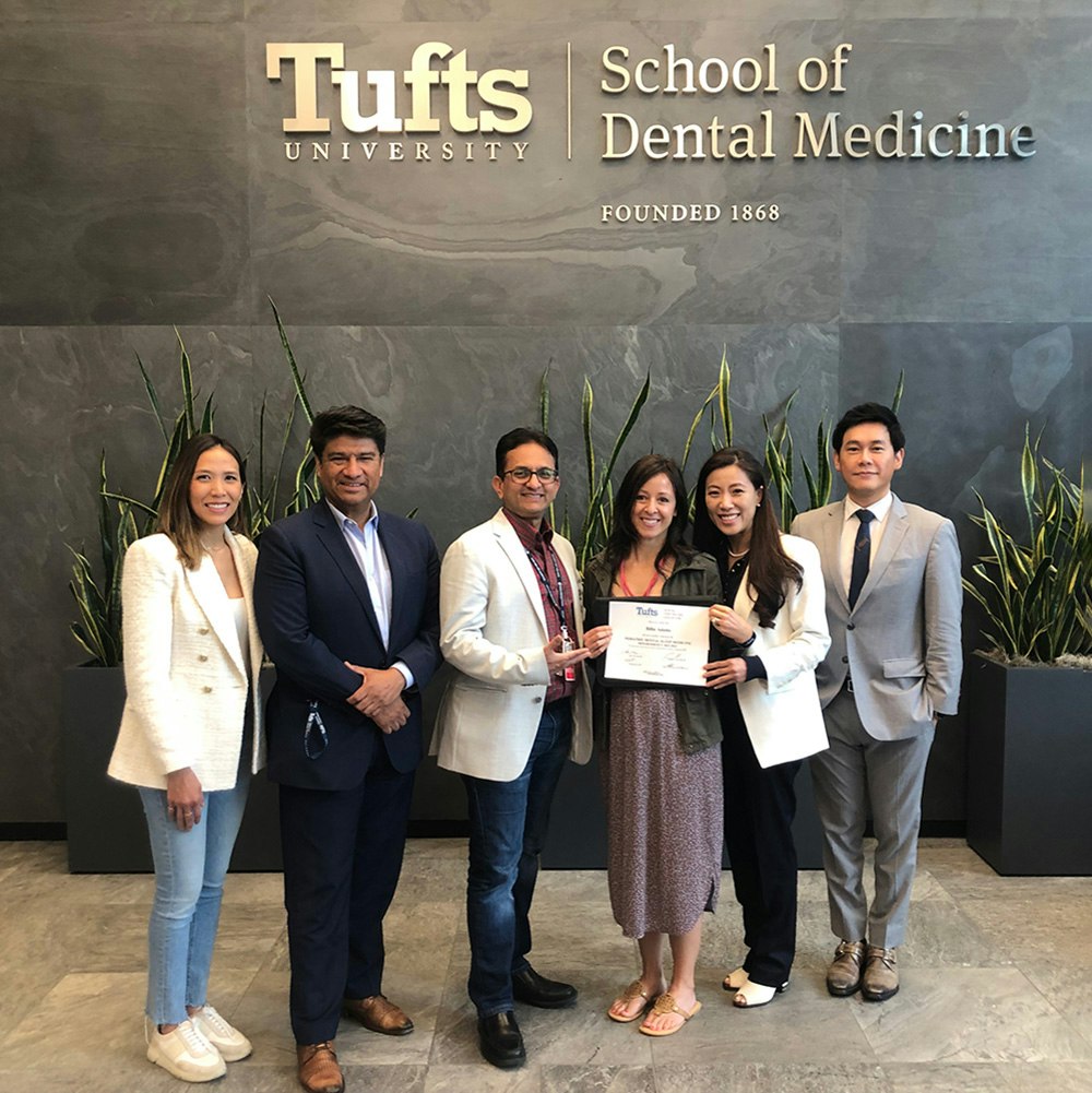Dr. Adams and team accepting an award at Tufts University School of Dental Medicine