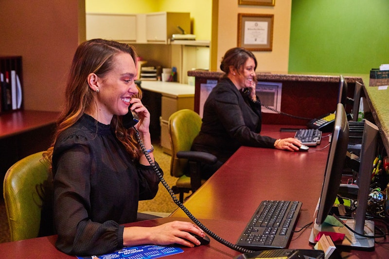 Front desk staff member on the phone