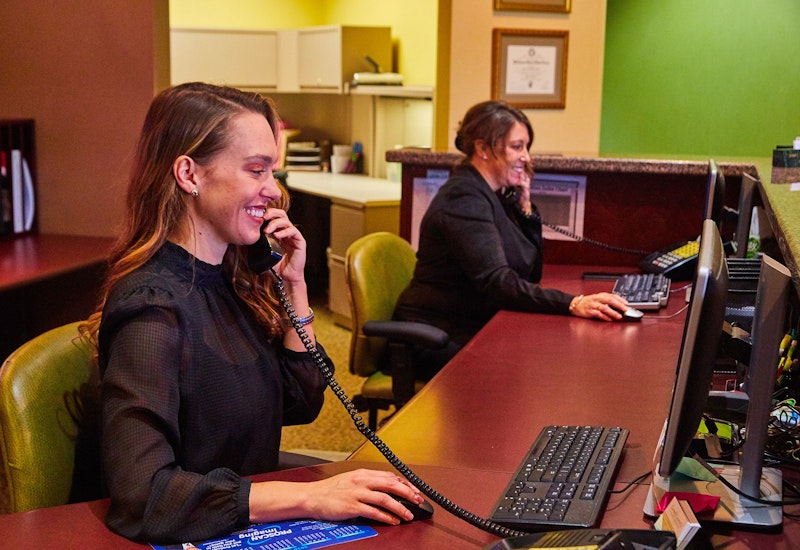 Front desk staff member on the phone