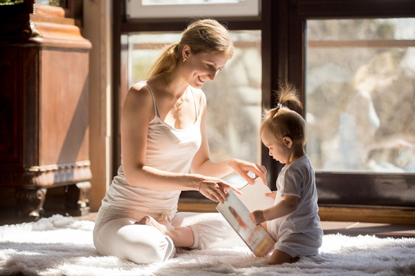 Young mom reading with baby