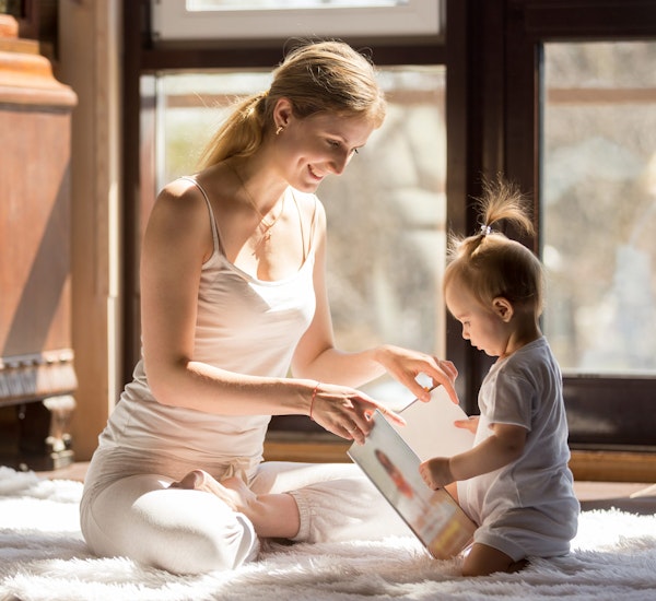 Young mom reading with baby