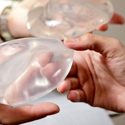 comparing Saline vs. silicone breast implants in hand