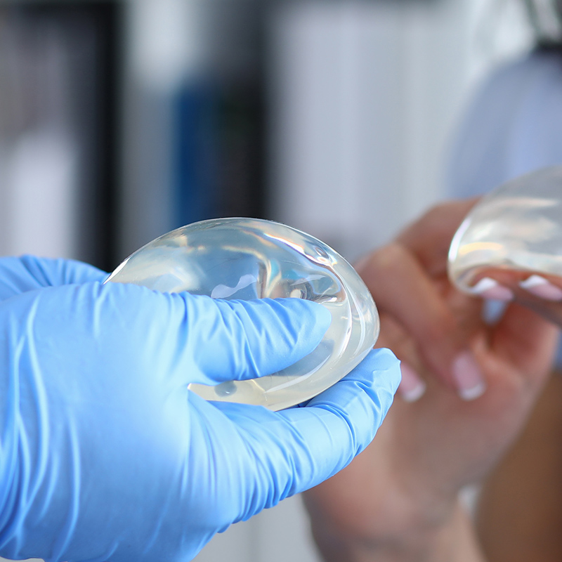 comparing Saline vs. silicone breast implants in hand