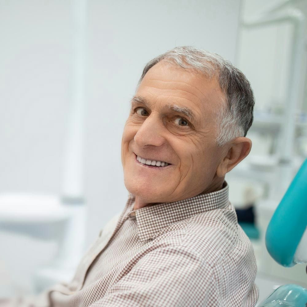 Smiling man in dental exam chair