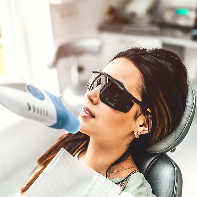Young woman getting her teeth professionally whitened