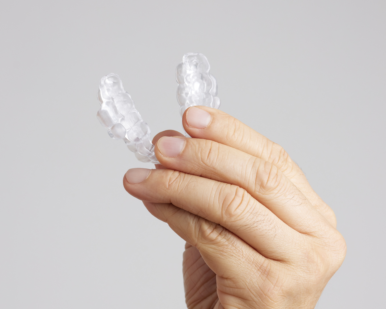 Person holding the ProSomnus oral appliance