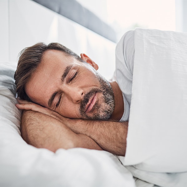 Man peacefully sleeping after treatment for sleep apnea