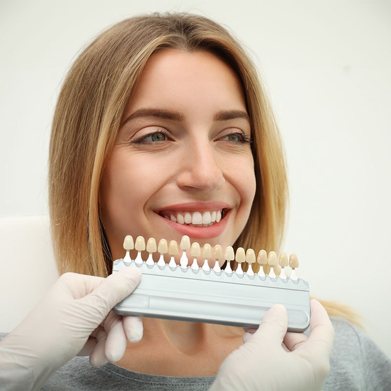 Woman being shade matched for veneers