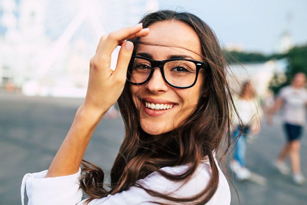 Woman in black glasses smiling