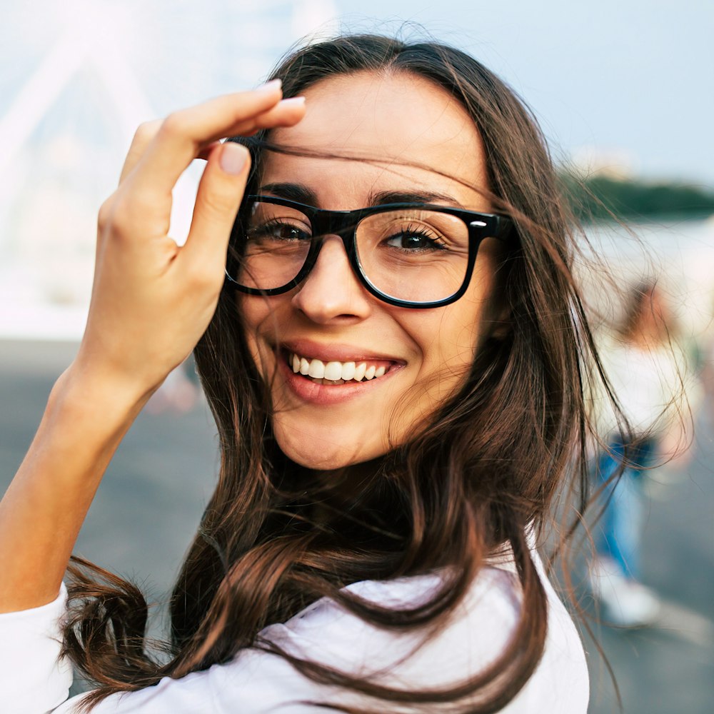 Woman in black glasses smiling