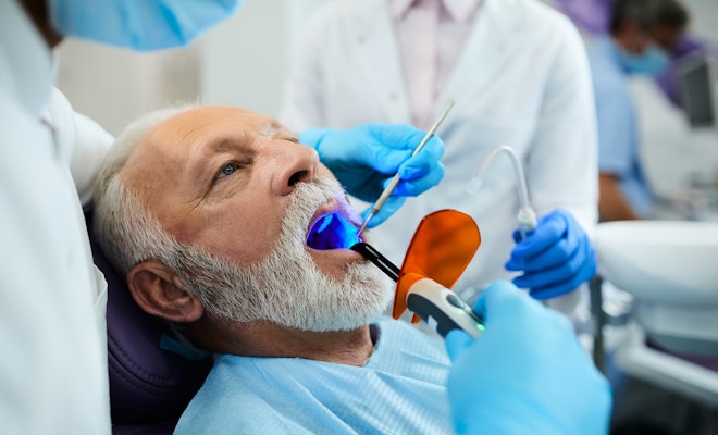 senior man getting a dental filling