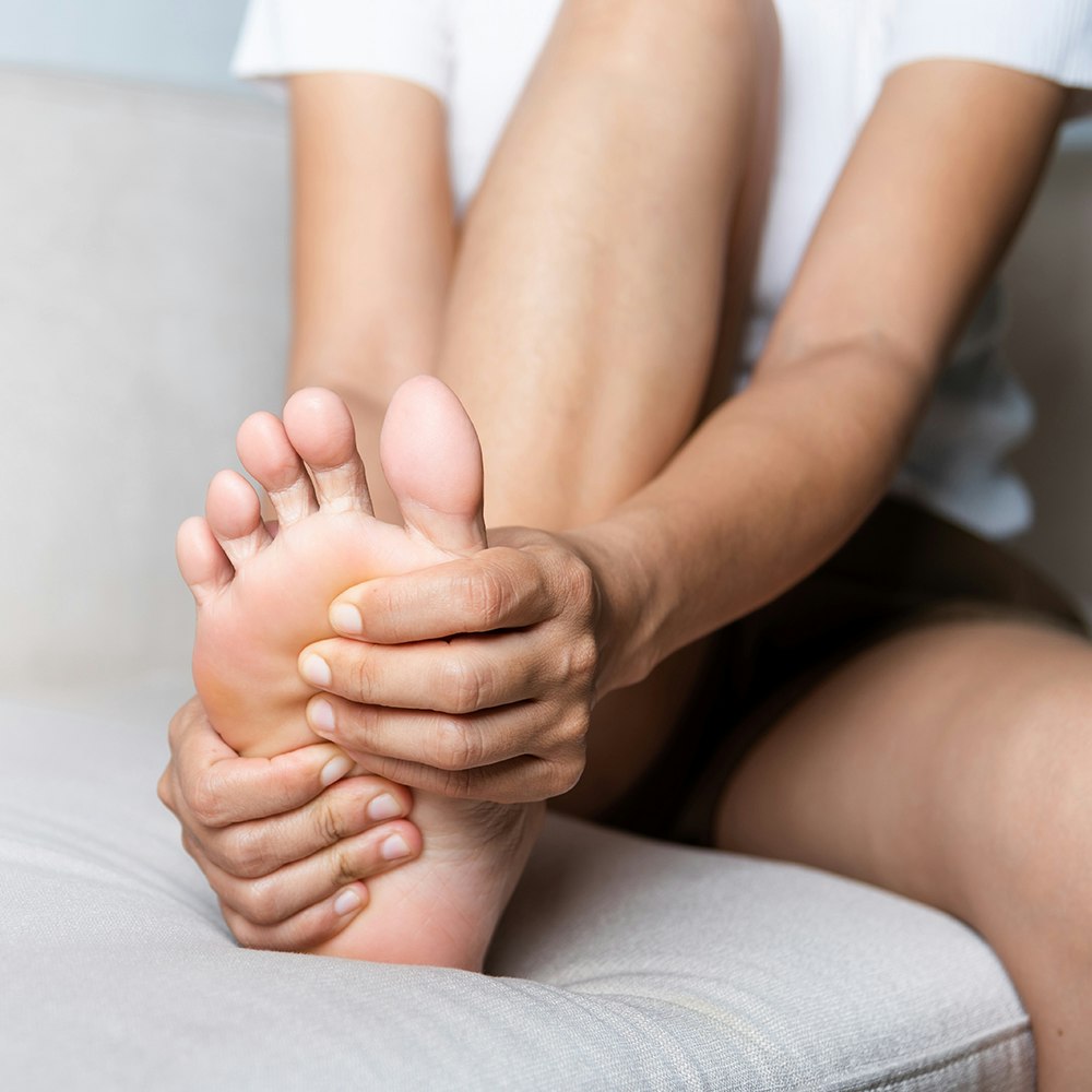 Person clutching foot