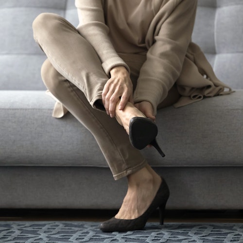 Plantar fasciitis patient clutching foot