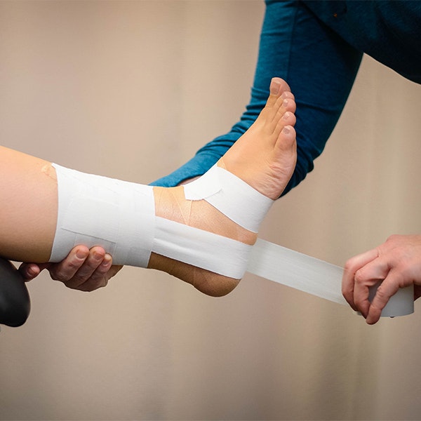 Person getting their ankle taped