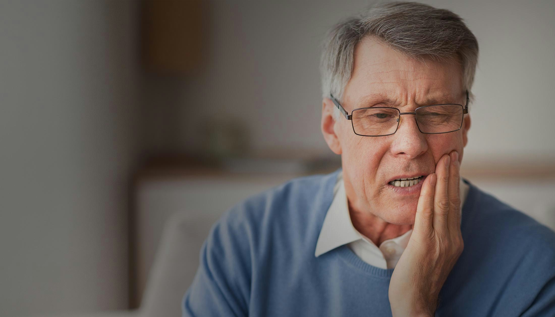 Woman examining new teeth at the dentist's office