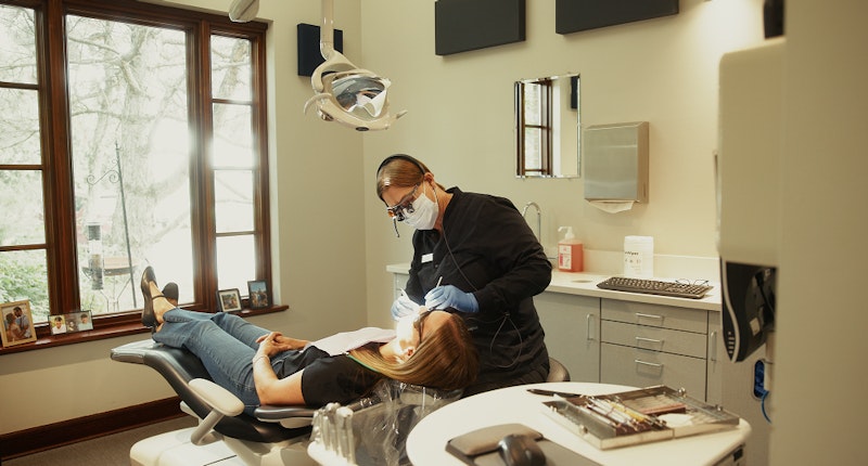 Signature Dental team giving client a cleaning exam