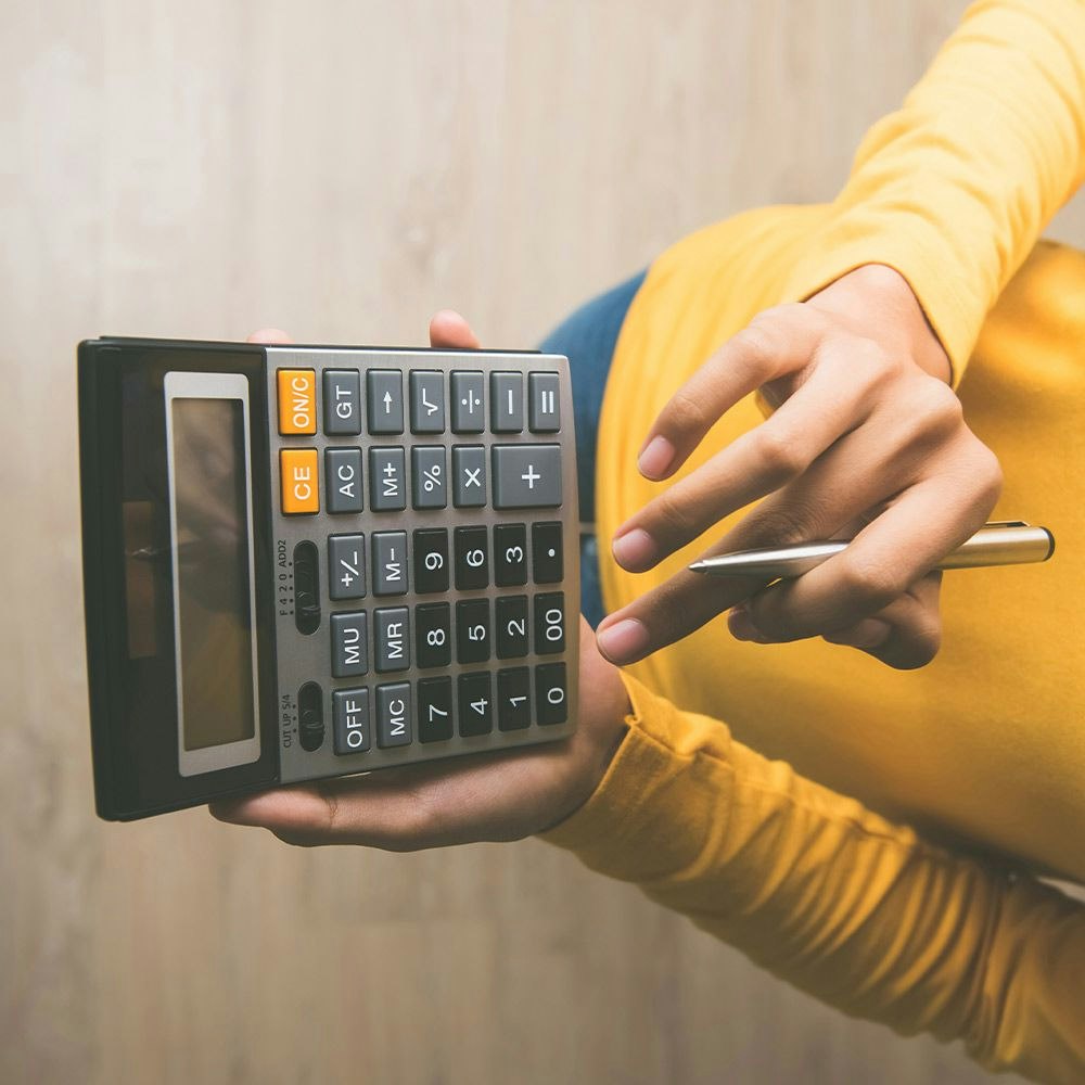 A person holding a calculator
