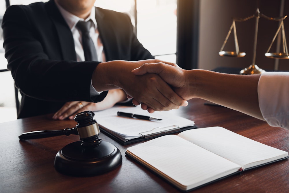 Lawyer shaking hands with client