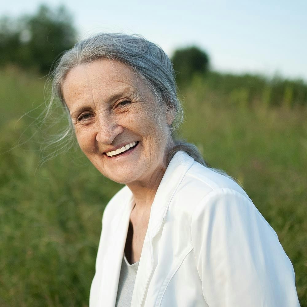 Smiling older woman in a field