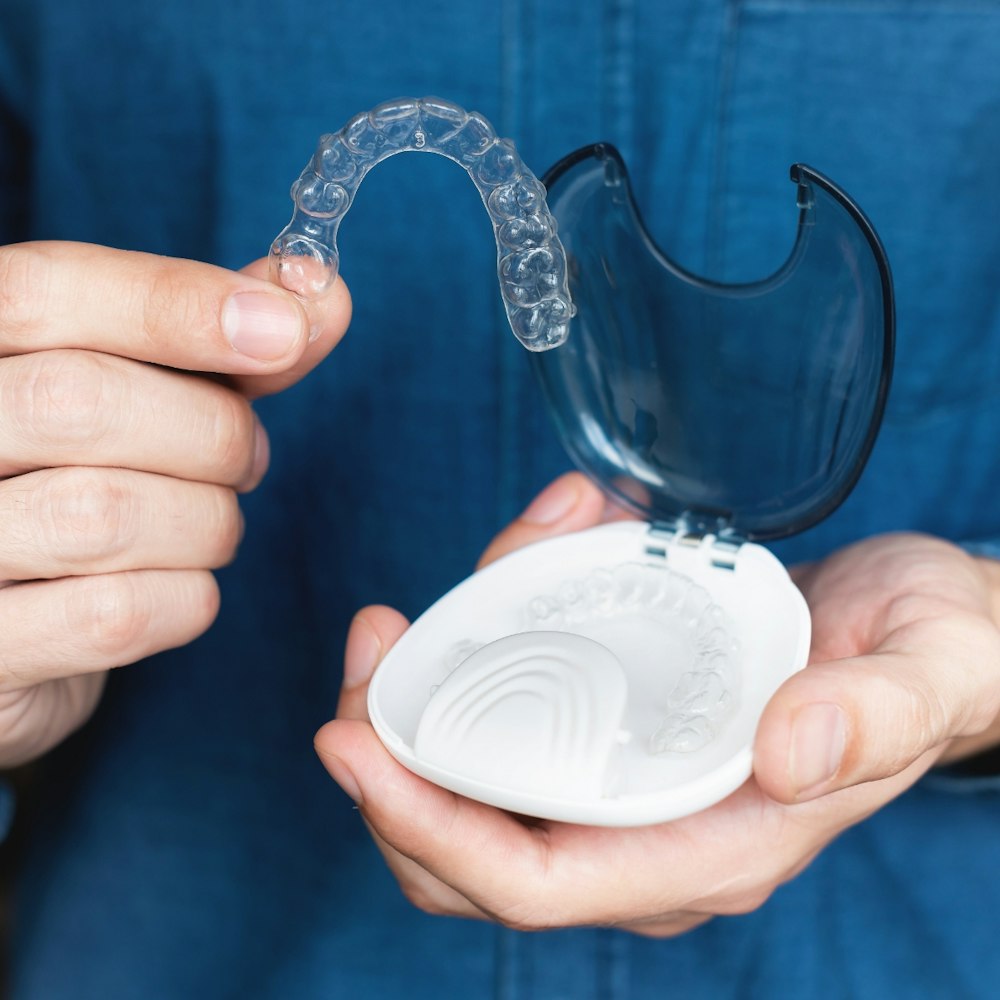 Man placing Invisalign in case