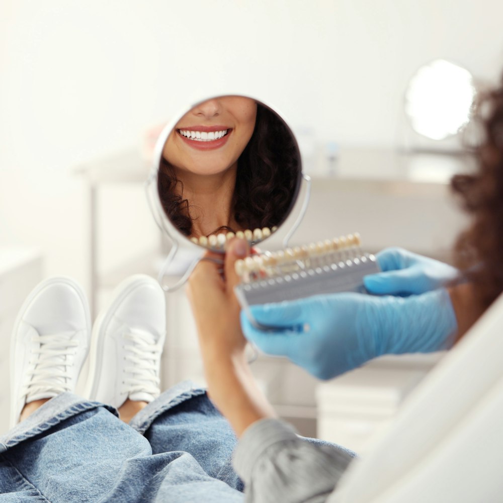 Woman looking at veneer shades at the dentist