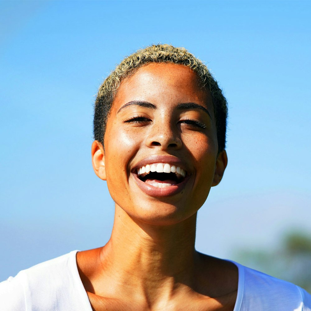 Laughing woman who has worn a retainer to maintain her smile