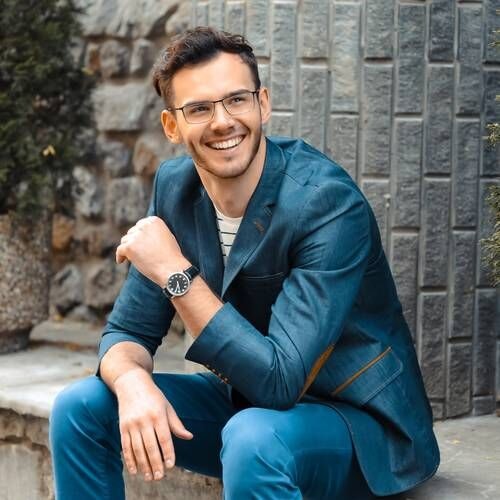 Sitting, smiling man in casual suit
