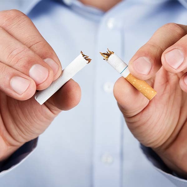Man splitting cigarette in half