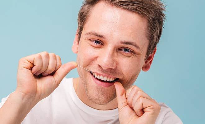 man flossing