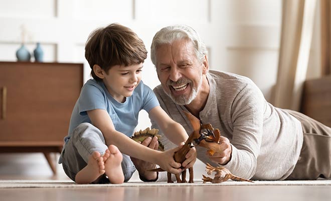 man playing on the floor with child