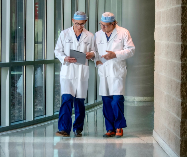 Dr. Cribbins and Dr. Chen looking at finances